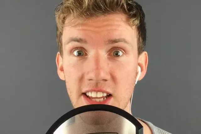 Christian James speaks into a condenser microphone.
