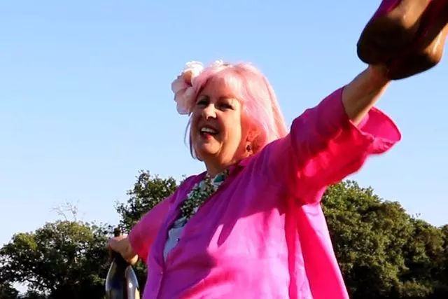 Claire Moore wears a pink jacket in a field