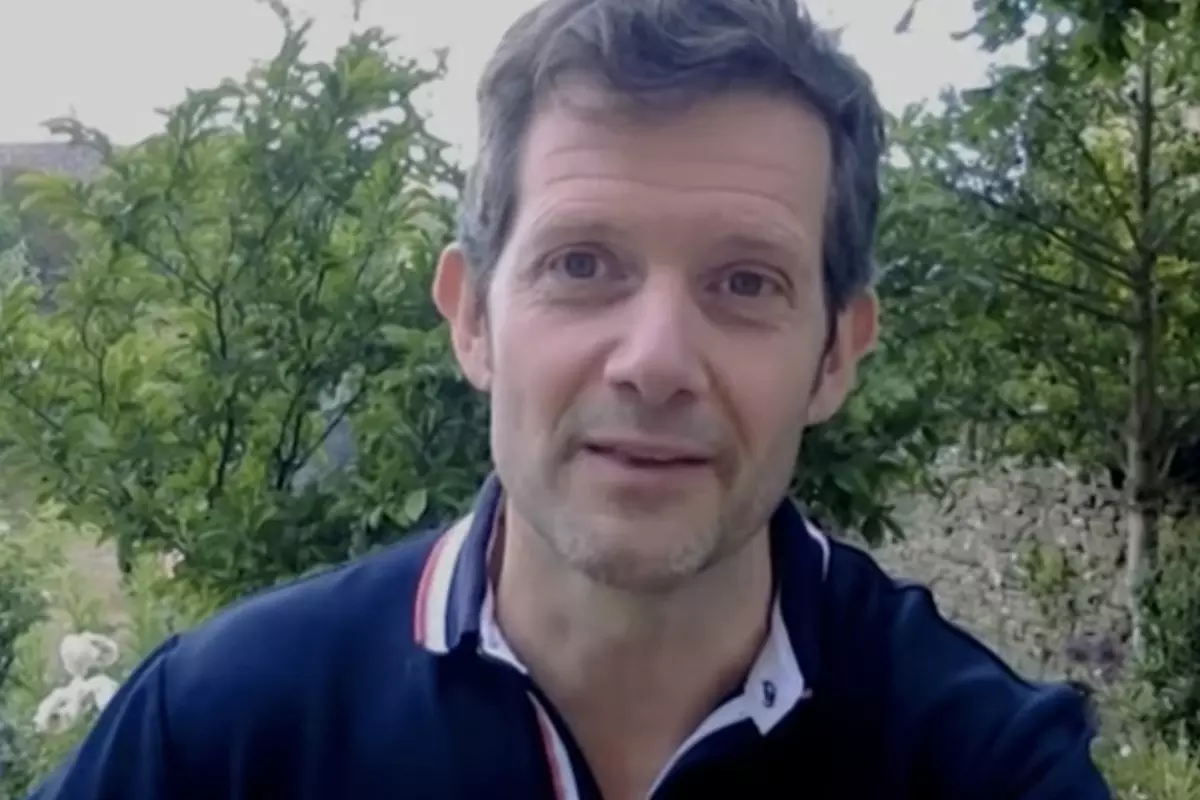 Professor John Frater against a background of trees